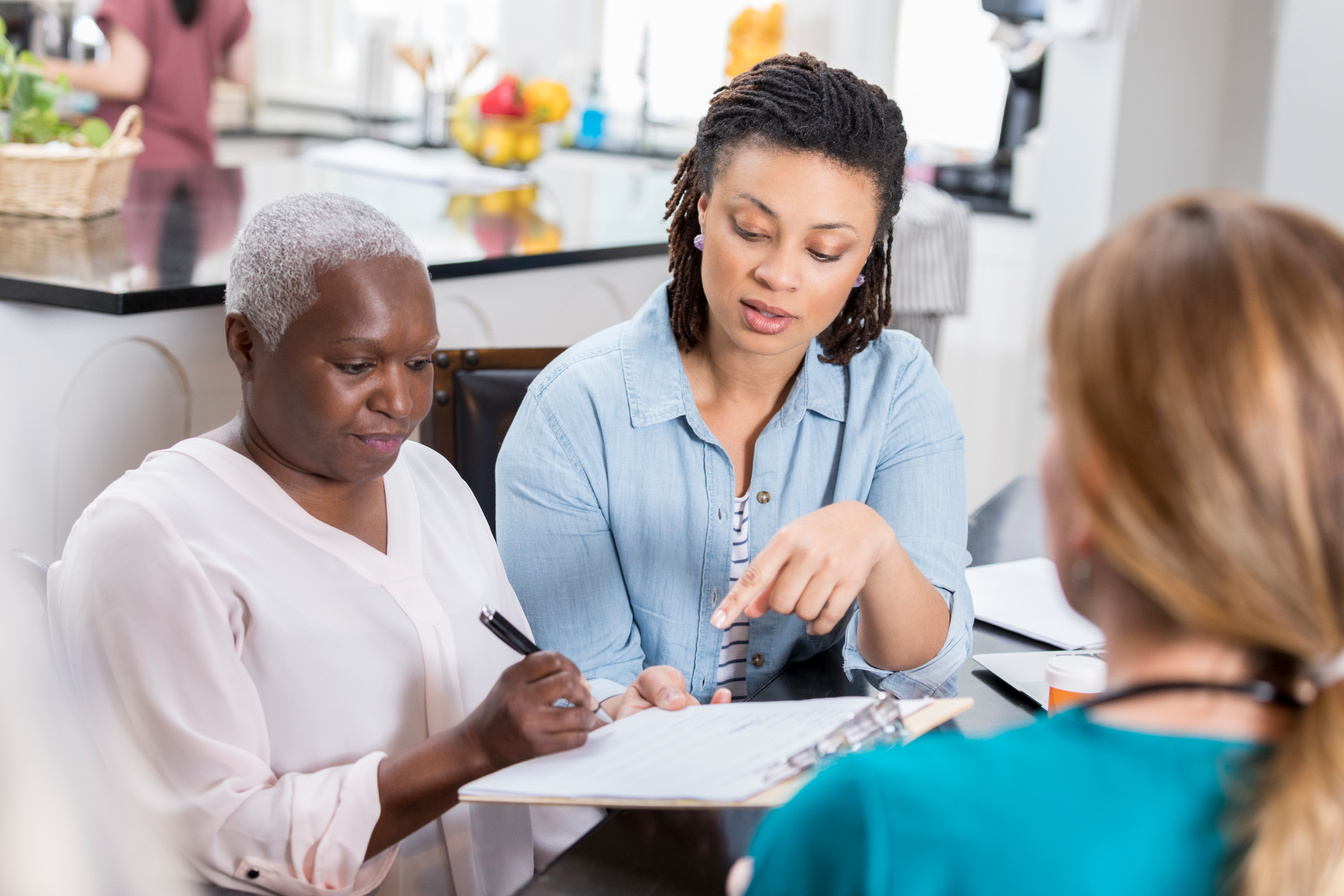 Adult daughter helps elderly mom with medical paperwork